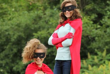 Two teenagers dressed as superheroes, representing the journey to emotional intelligence as inspired by Dr. Cath Covacin.